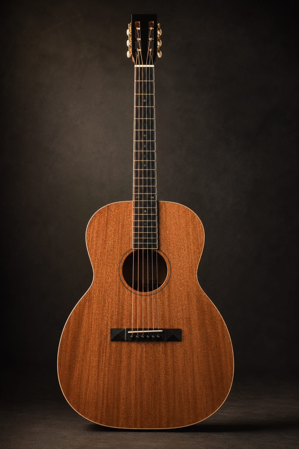 Manifestation I — an all-mahogany 000-style 12-fret acoustic guitar with slotted headstock, hand-built by luthier Devon Stone of Stone Guitars in Birmingham, Alabama, photographed full-length under warm studio light.